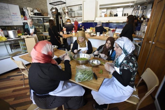 Syrian refugee women cooking at a Middle Eastern food pop up at a restaurant in Toronto.
