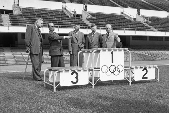 Officials in Finland inspect an Olympic medals podium prior to the 1952 Helsinki Games.